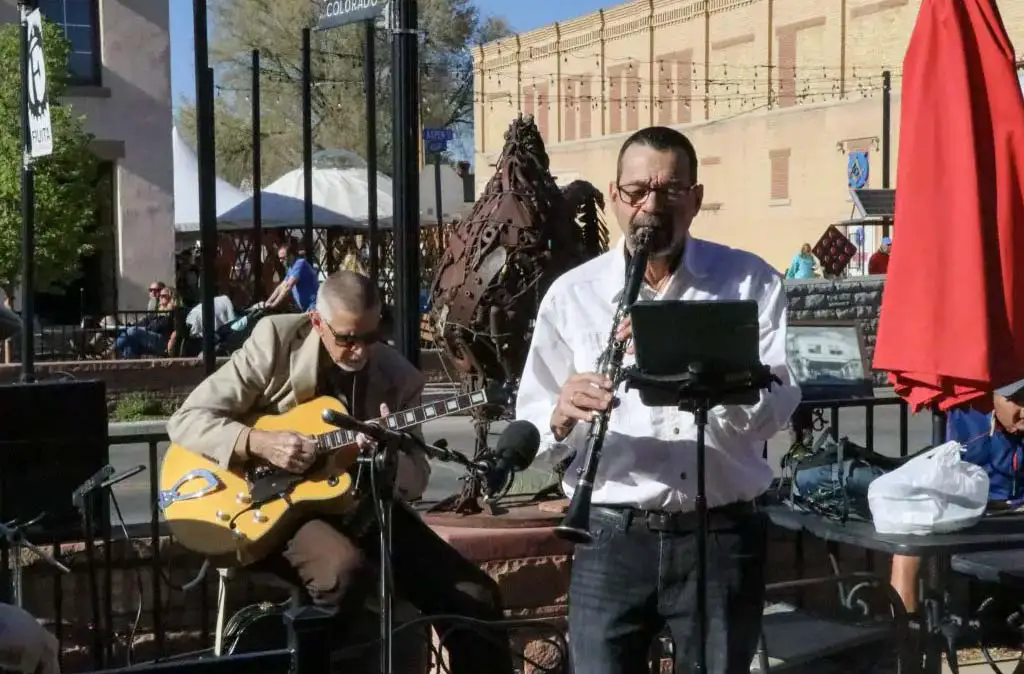 Photograph of Mick Wilson playing the clarinet with guitarist from PB&J Jazz outside Aspen Street Coffee in Fruita, CO taken by Luke Hanna