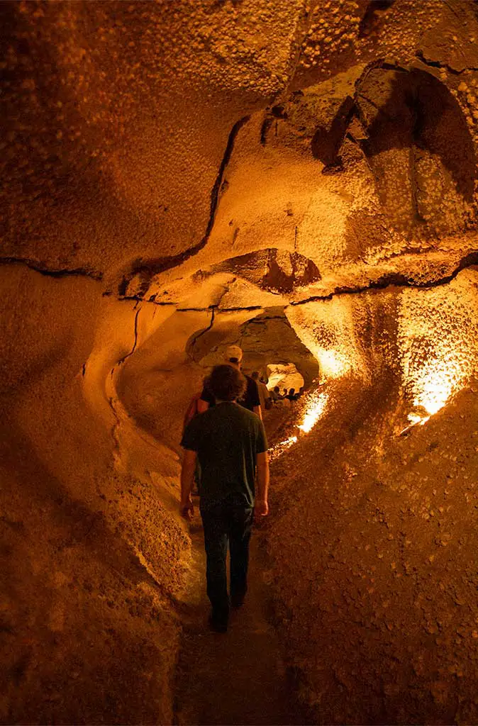 Photo take of a tour group walking single file through the Caverns of Sonora tour.