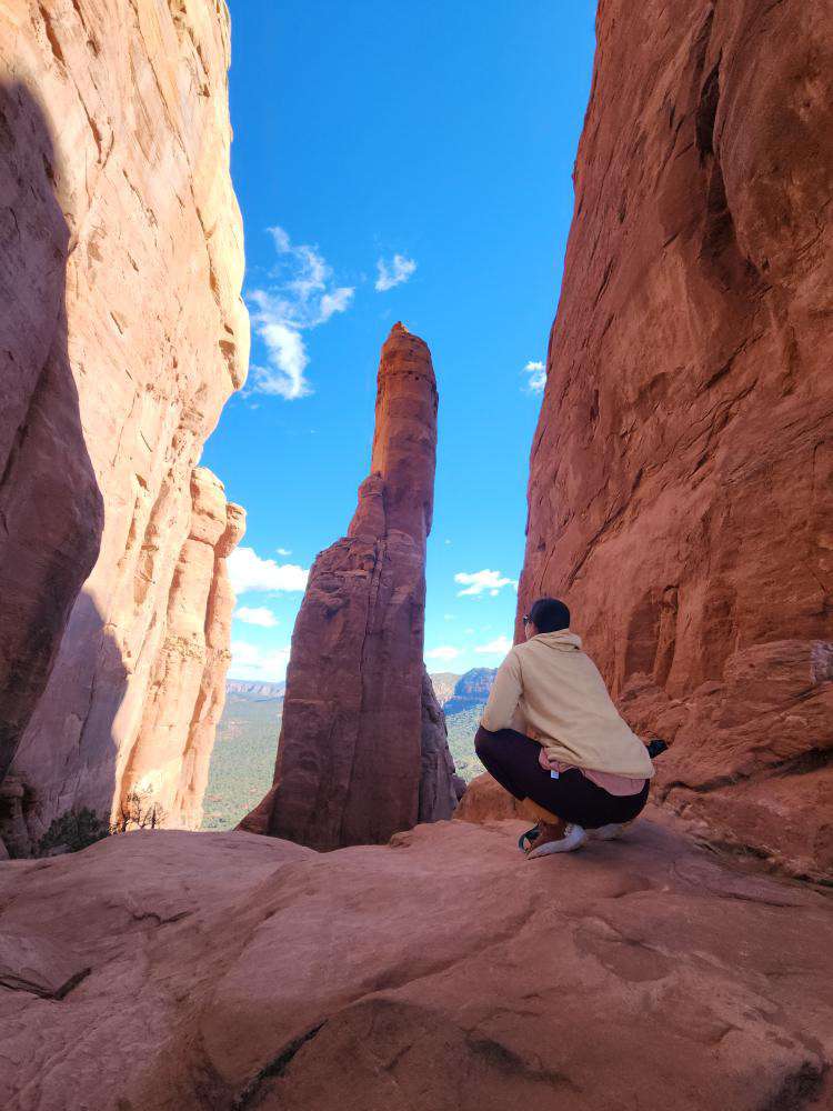 Stephanie sitting at the Cathedral Rock vortex for Applied Worldwide blog "Feeling the Energy: Hiking Cathedral Rock Vortex in Sedona"