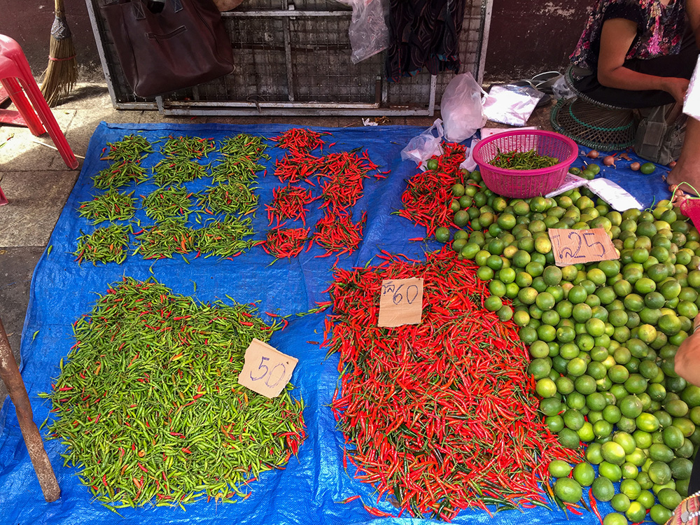 Photo of vibrant Thai chilies and limes at a market in Thailand for Applied Worldwide blog "A Thai Odyssey: Why This Country Tops The Tourist Rankings"