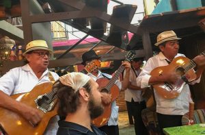 Photo of man surrounded by a Mariachi band in Mexico for blog on Experiential Travel and the Essence of Authentic Exploration