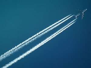 Photo of a plane in the sky for Applied Worldwide lifestyle blog titled "Tips For Reducing A Fear Of Flying"