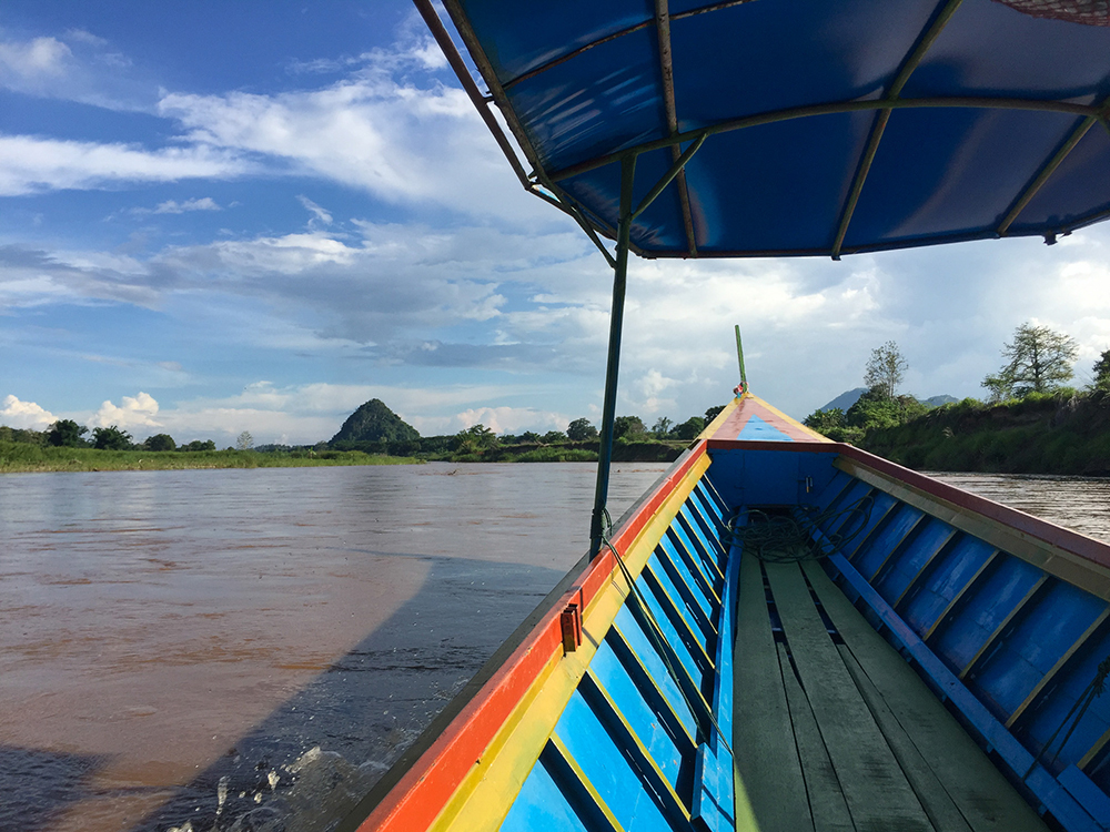 POV photo in a long-tail boat on a river in Northern Thailand for Applied Worldwide blog "A Thai Odyssey: Why This Country Tops The Tourist Rankings"