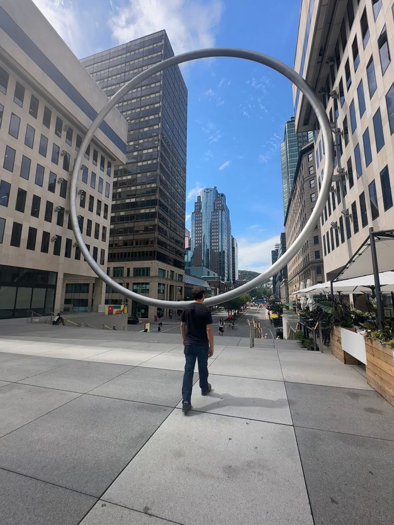 Photo of Luke walking in downtown Montreal for Applied Worldwide blog "5 Types of Family Vacation Everyone Should Love"