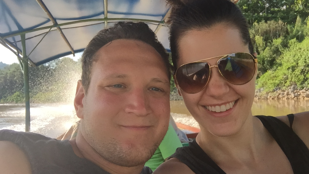 Photo of Luke and Stephanie in Thailand on a long-neck boat for Applied Worldwide blog Why Thailand Is One of the Most Romantic Places to Propose