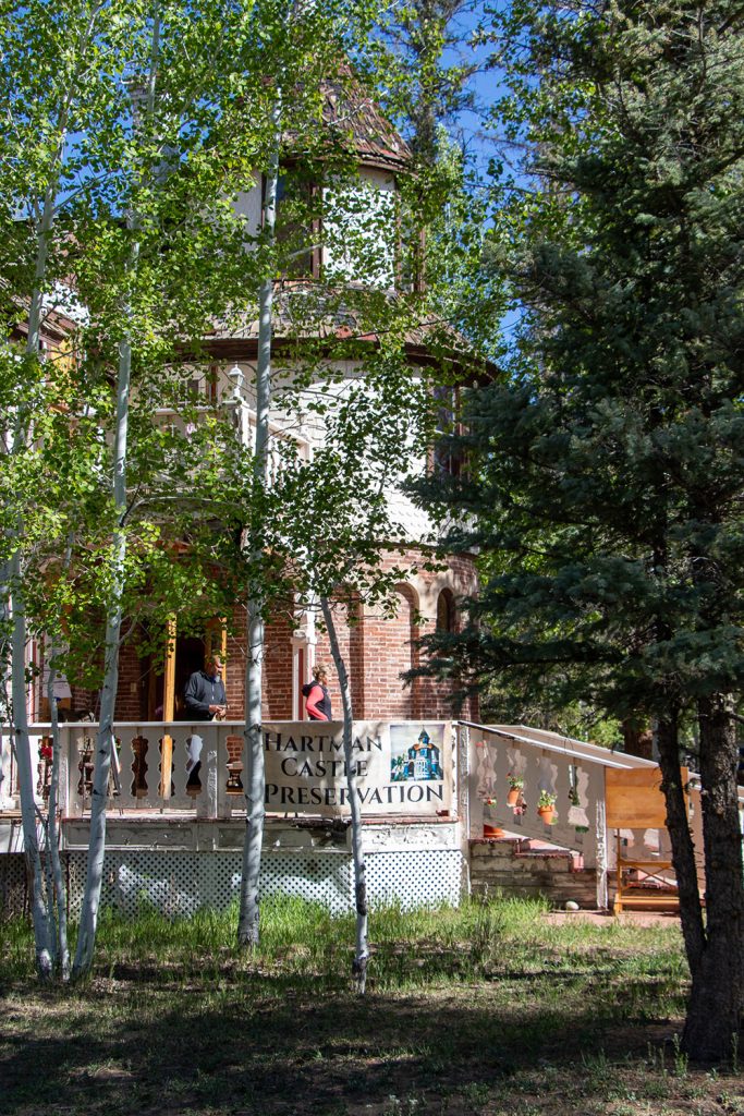 Hartman Castle under the shade of aspen trees for Applied Worldwide blog "Hartman Castle Welcome Community for First Time in Century"