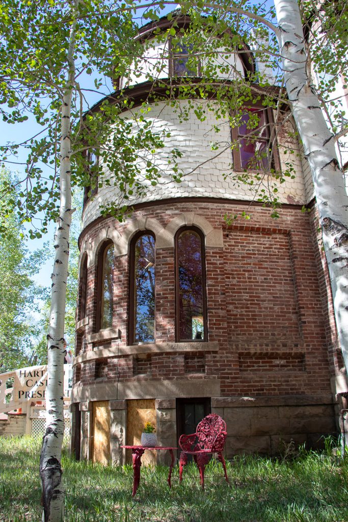 Hartman Castle tower under the shade of aspen trees for Applied Worldwide blog "Hartman Castle Welcome Community for First Time in Century"