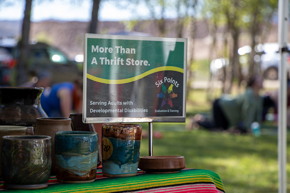 Photo of six points thrift sign reading "more than a thrift store" at the Hartman Castle Art Fair for Applied Worldwide blog "Hartman Castle Welcome Community for First Time in Century"