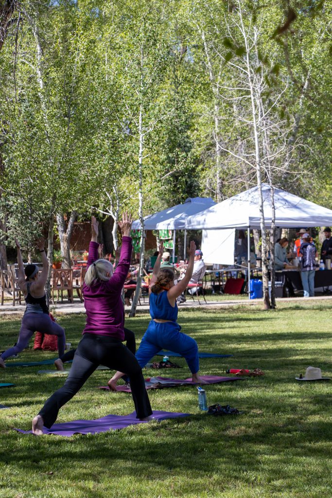 Group of community members in the midst of a morning yoga flow from Dragon yoga for Applied Worldwide blog "Hartman Castle Welcome Community for First Time in Century"
