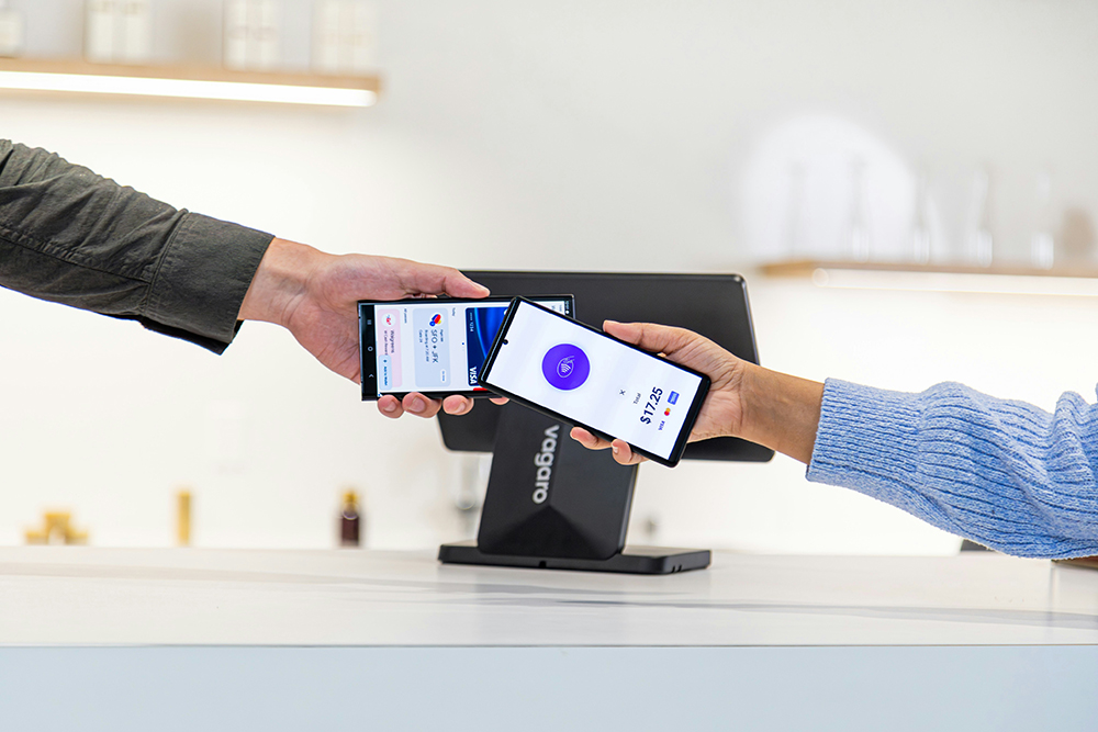 Photo of two phones making a contactless payment for Applied Worldwide blog "Secure Your Digital Lifestyle: Protecting Online Income"