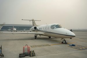 A white private jet parked on an airport tarmac for Applied Worldwide blog "The Strategic Benefits of VIP Airport Services"